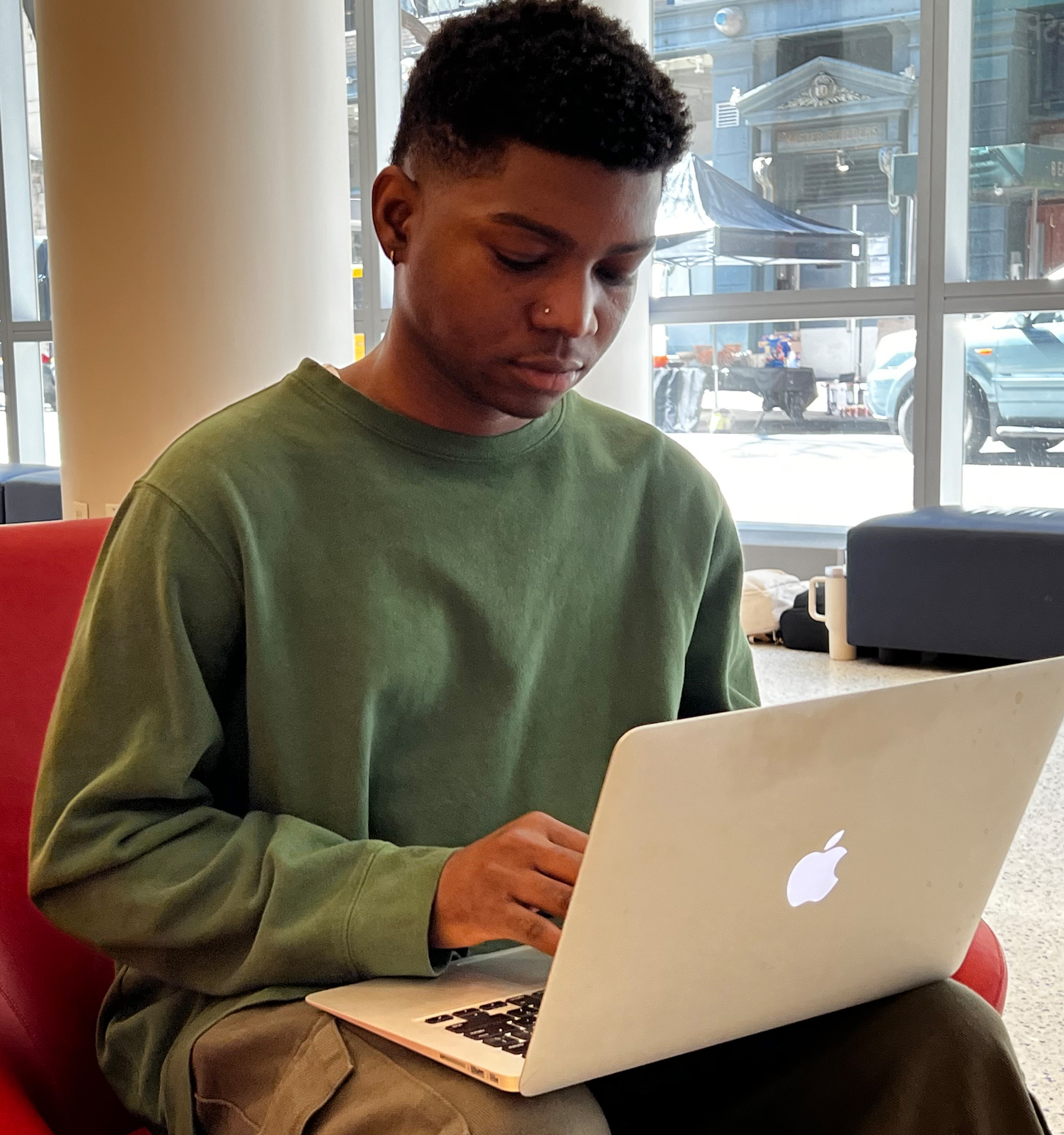 NYU student works from a Mac laptop.